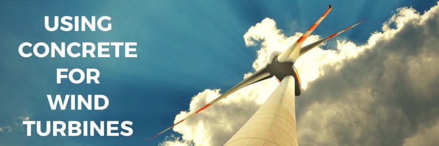 View of a wind turbine from below, with the sun behind a cloud and blue sky