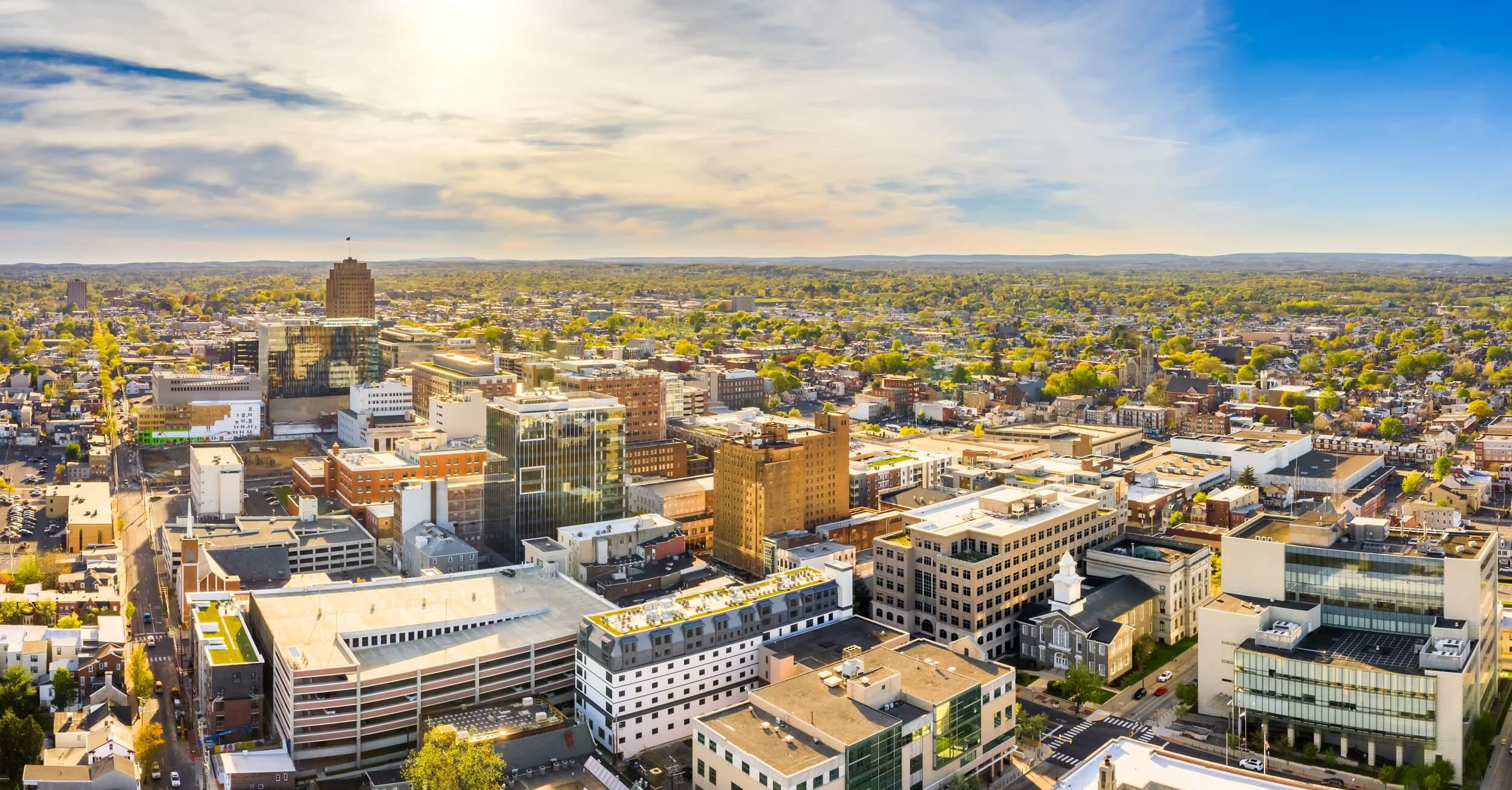 city full of buildings and green trees