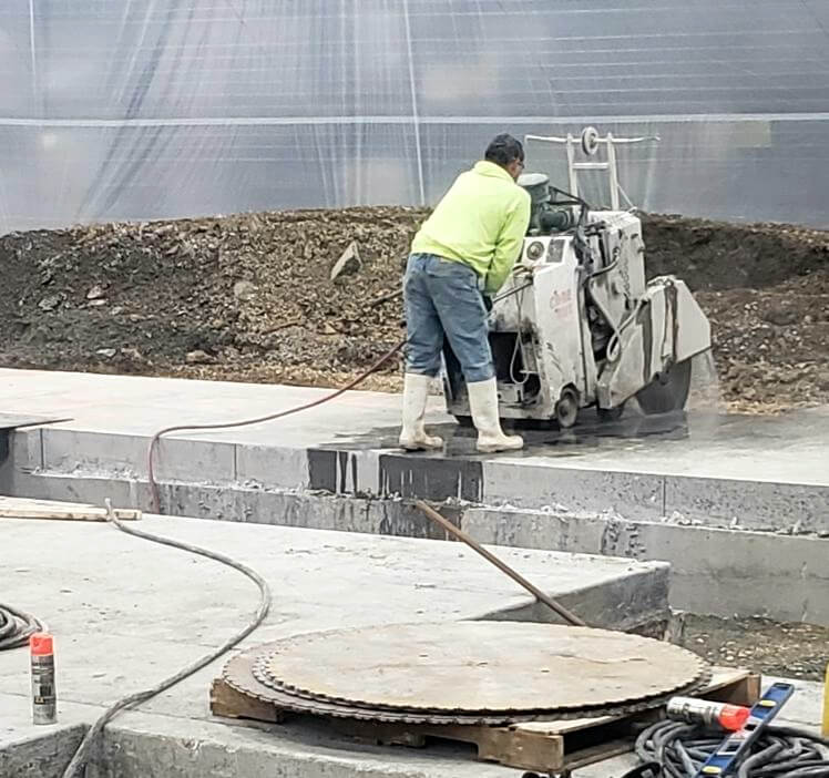 worker cutting concrete