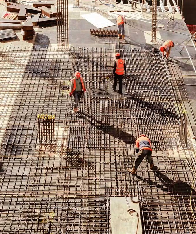 five workers working on construction site