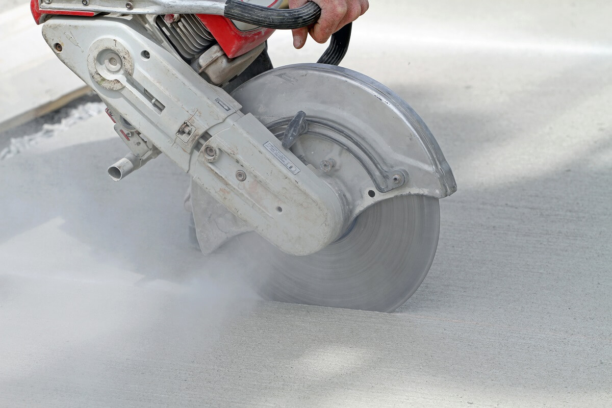 closeup of saw cutting through concrete