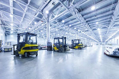 three forklifts in a warehouse