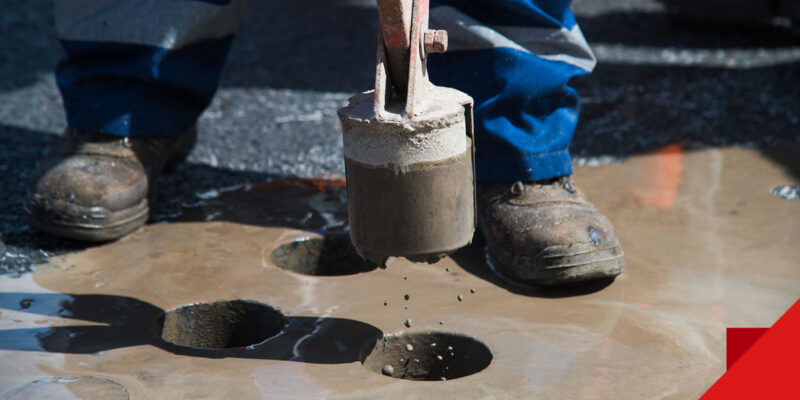 worker using concrete core drill